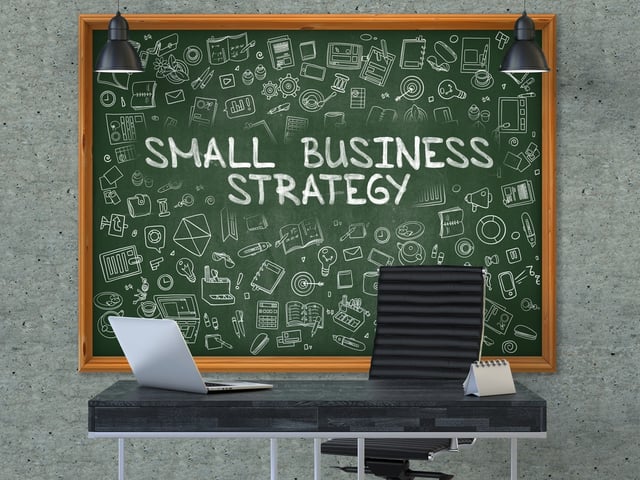 Small Business Strategy. Green Chalkboard on the Gray Concrete Wall in the Interior of a Modern Office with Hand Drawn Small Business Strategy. Business Concept with Doodle Style Elements. 3D..jpeg